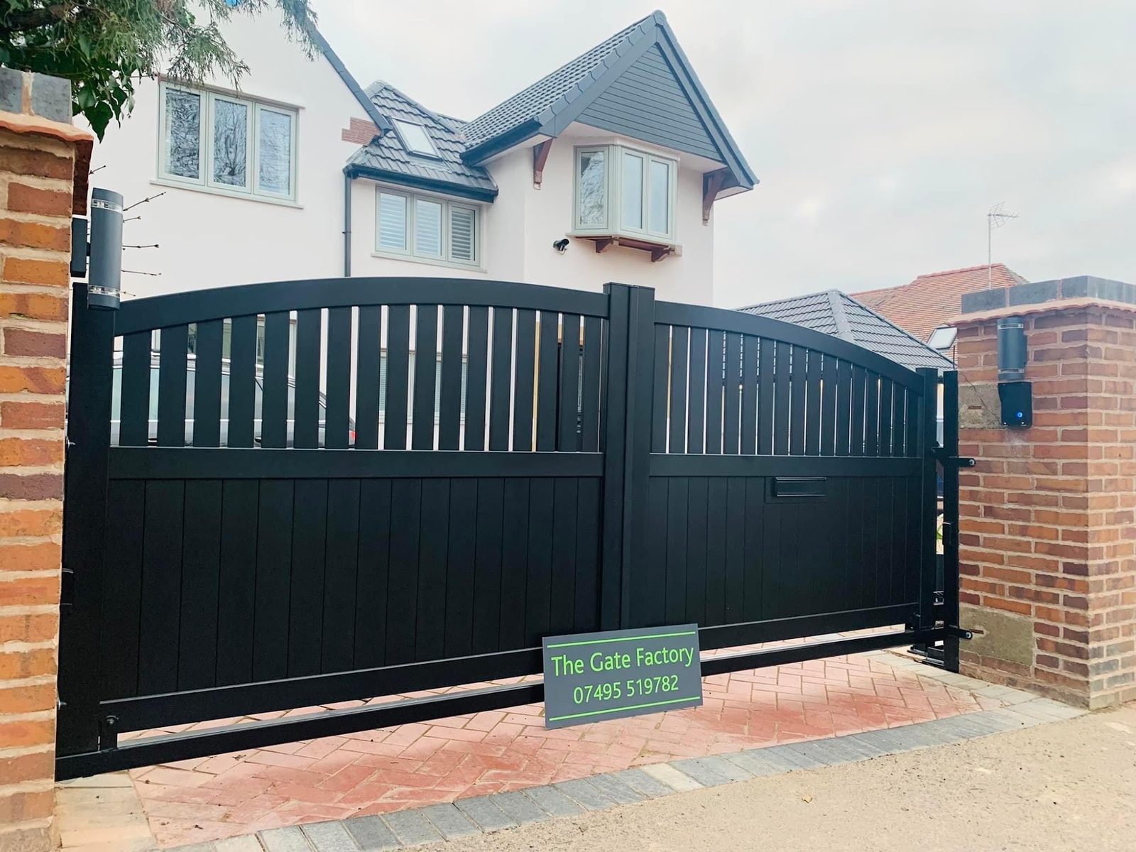 Board infill driveway gates on a brick pier, The Gate Factory near Old Hill station, Old Hill B64