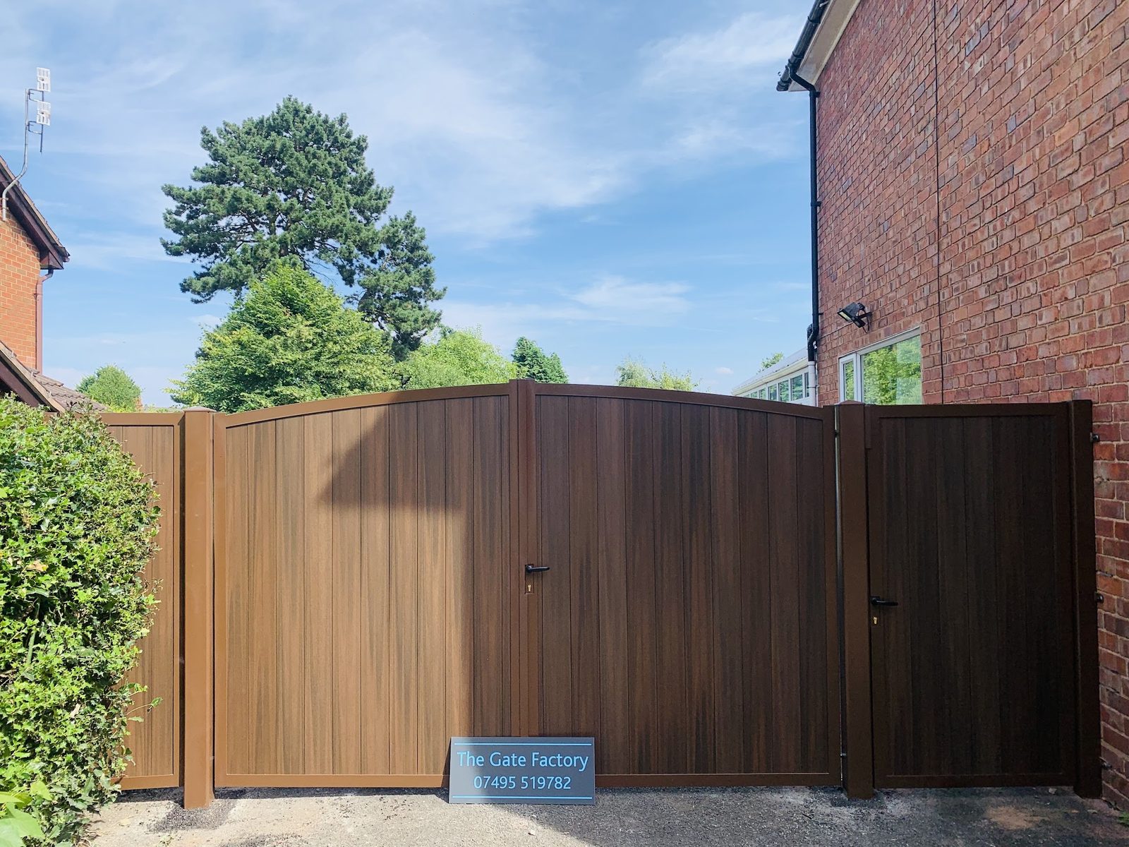 Timber effect board gates between brick walls, The Gate Factory near Netherton High Street, Netherton DY2
